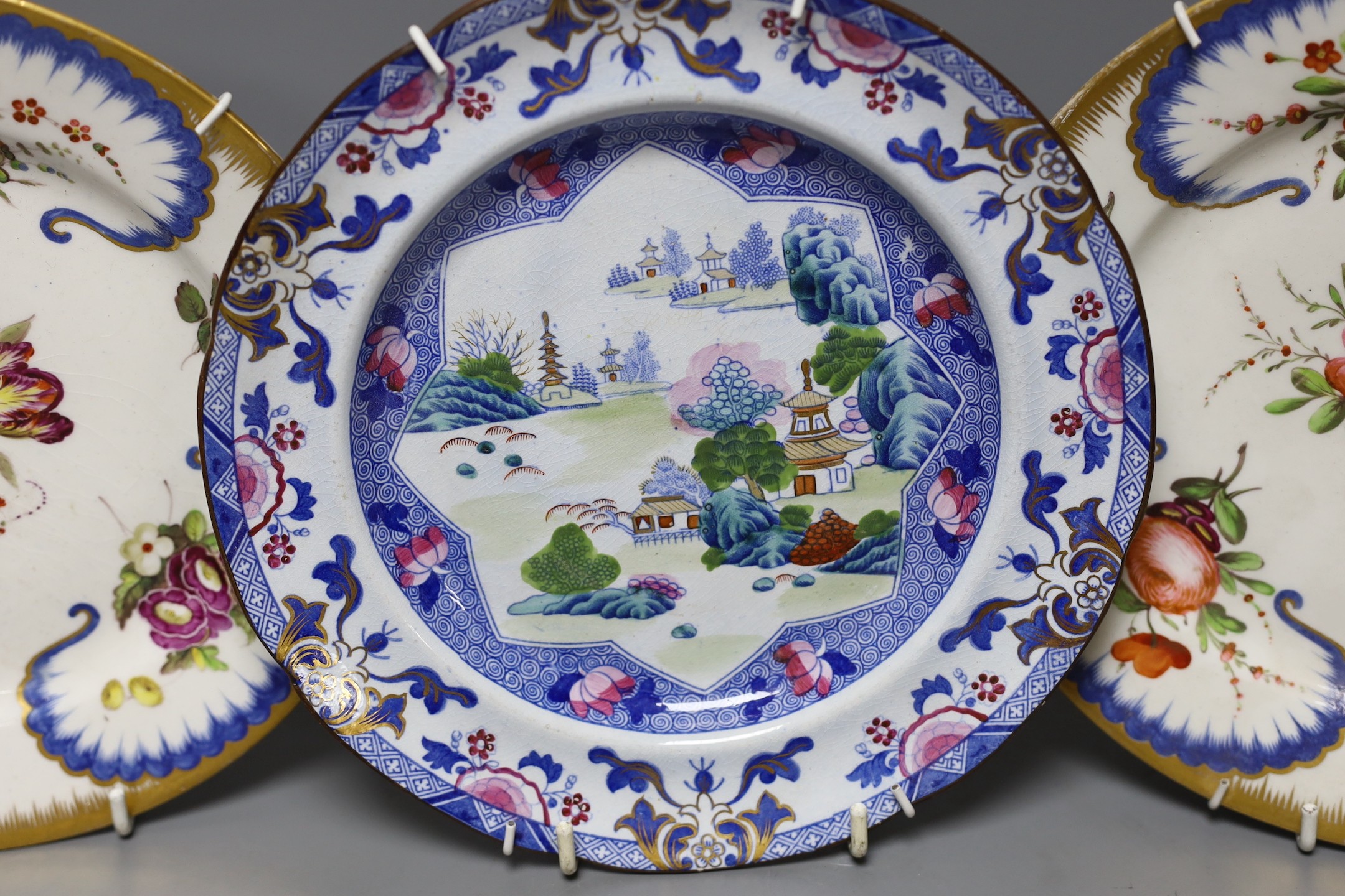 An stone china plate and a pair of Coalport floral plates, c.1815, Ironstone plate 22cms diameter